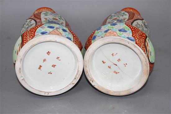 A pair of Japanese enamelled porcelain huqqa base vases, decorated with figures, height 25cm